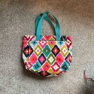 Beautiful canvas tote- very sturdy. Lots of zip pockets! 13 in tall, 18 across